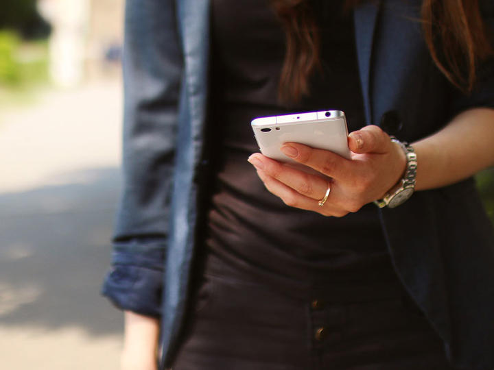 image of woman holding a phone