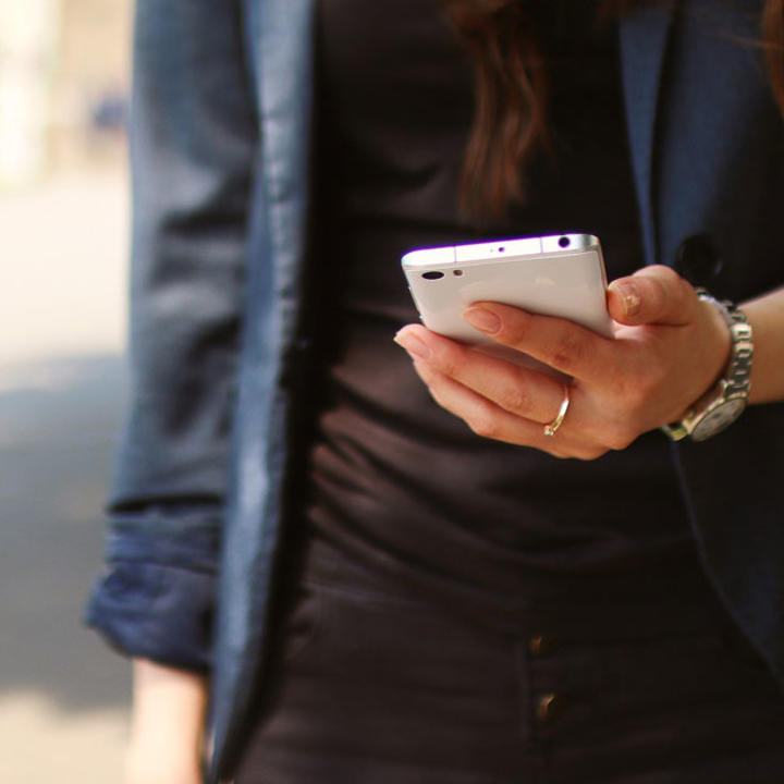 image of woman holding a phone